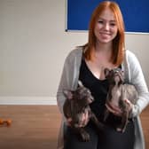 RSPCA rretail development coordinator Natalie Flanagan with French Bulldog puppies Bayley and Finn on the flooring donated by Flooring Superstore.