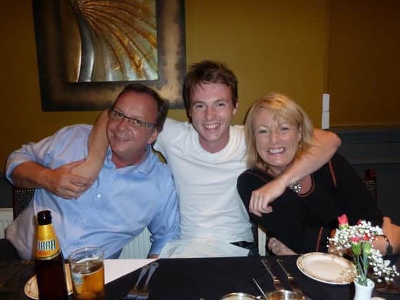 Luke Billups (middle) with dad David and mum Christine