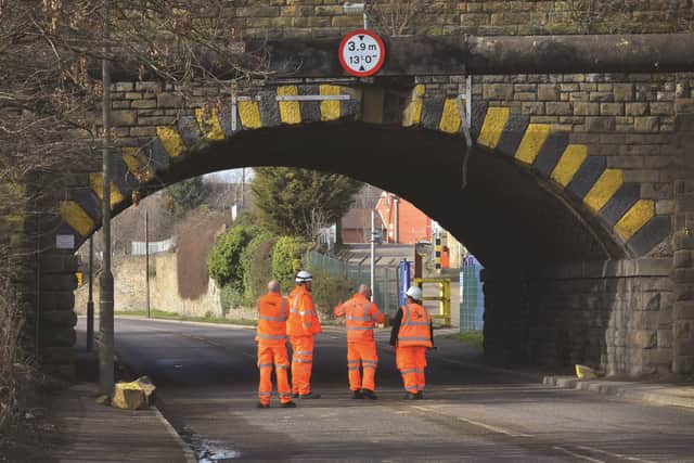 Network Rail workers survey the damaged bridge at Aldwarke Lane yesterday (Monday).