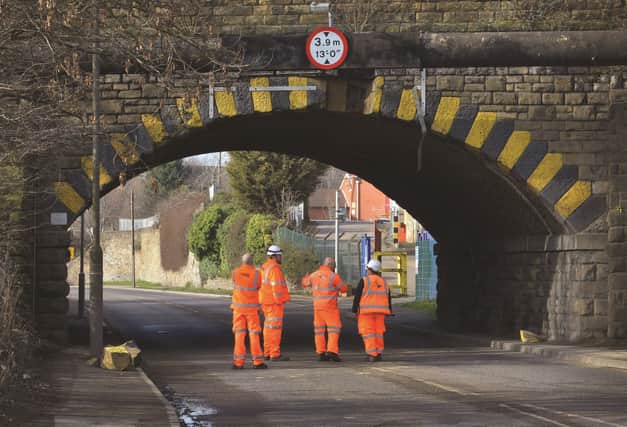 Network Rail workers survey the damaged bridge at Aldwarke Lane yesterday (Monday).