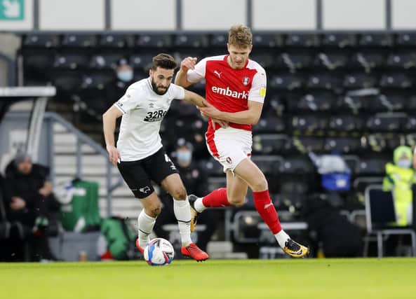 Michael Smith up against Derby County's Graeme Shinnie. Picture by Jim Brailsford