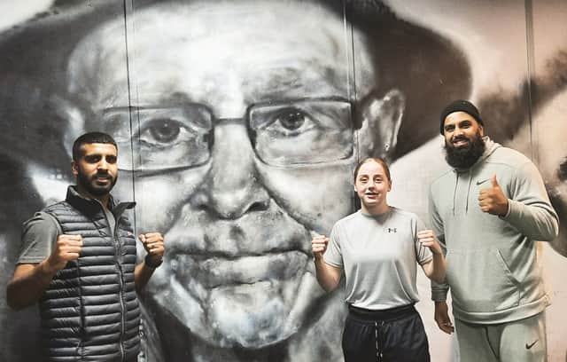 OLIVIA DUNLEAVEY in front of a portrait of the late, great Brendan Ingle with Atif Shafiq and Abdul Ali.