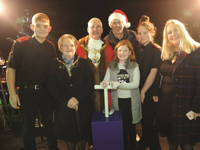 The mini Deputy Mayor, Olivia Hodges, pushes the switch to turn on the lights. Also pictured (from left to right) are, Korben Smith, Fire Cadet, The Mayor and Matyoress of Rotherham, Cllr and Mrs Alan Buckley, Rother FM breakfast DJ, Stewart Nicholson, Jorja Bailey, Fire Cadet and Deputy Mayor, Cllr Jenny Andrews. 184595-10