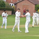 Whiston Parish Church celebrate a wicket in their league match at Conisbrough earlier this season.