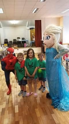Liam’s brothers Levi (left) and Rory and sister Graci with Spiderman and Elsa.