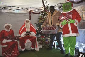 Sabelo Ncube (second from right) with (from left to right), Claire McCafferty, Santa, and Mika McCafferty. 210976-1