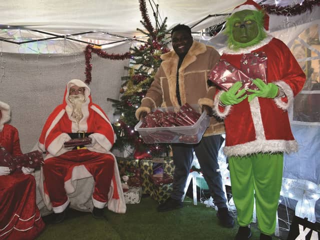Sabelo Ncube (second from right) with (from left to right), Claire McCafferty, Santa, and Mika McCafferty. 210976-1