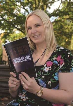 Wales High School teacher Vicki Bolton with her novel Worlds Away