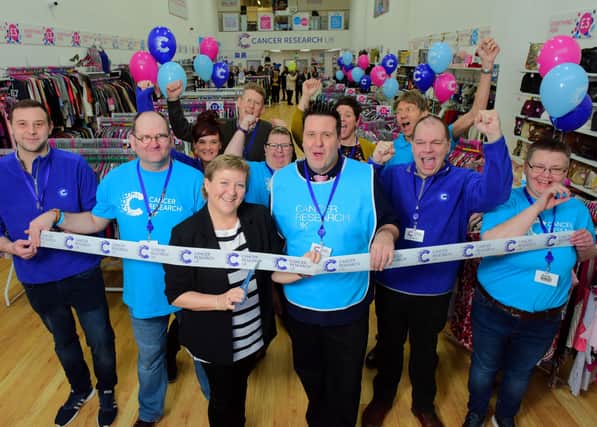 Helen Beck and Steve Parker-Wilson (centre) launch the shop with Cancer Research UK volunteers.