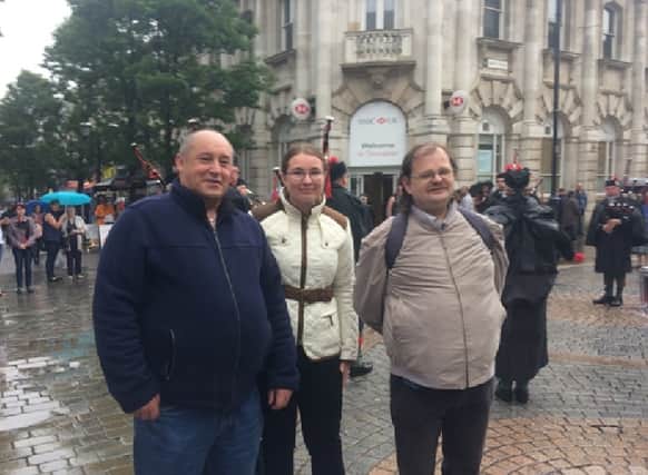 Left to right; David Brookes Waugh, from Pioneer Social Enterprise, Michelle Scholey from Pay It Forward and Sean Parker, volunteer with Pioneer Social Enterprise, with Sheffield Pipe Band playing in the background.