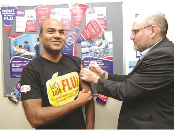 Seen getting his jab is practice doctor Uday Idukallu from his colleauge, Dr Richard Cullen, chair Rotherham CCG.