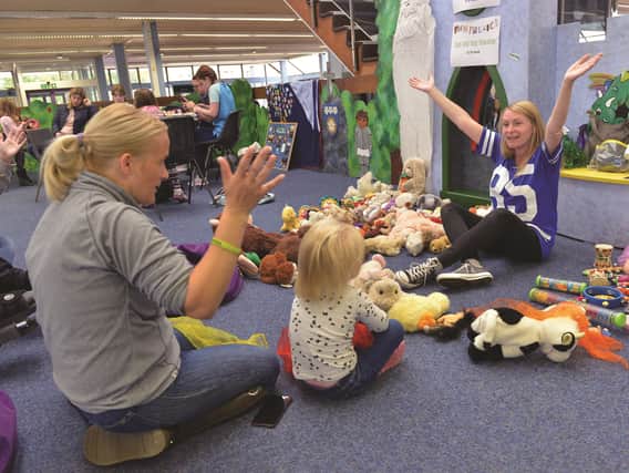 Anne-Marie (left) and Lilly Jean Swallow had fun singing along with makaton tutor Rachel Downs during the recent Fun Palace event at Wath Library