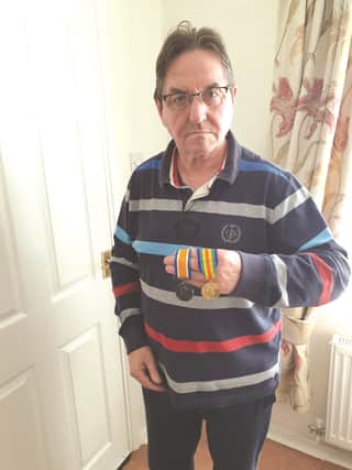 David Hobson with the medals he found among his late father's possessions.