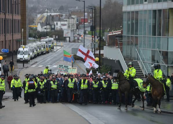 Members of the English Defence League make their way up Main Street