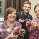 Louise Mould of Rawmarsh who set up the Rotherham Rocks Facebook page, pictured with her children Sam and Katy and their decorated stones. 180133
