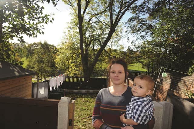 Gemma Levick and her son, Corey, in front of the ash tree