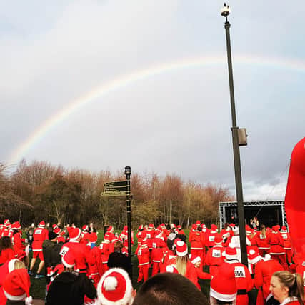 Dozens of Santas warm up under a winter rainbow.
Picture: Rotherham Hospice