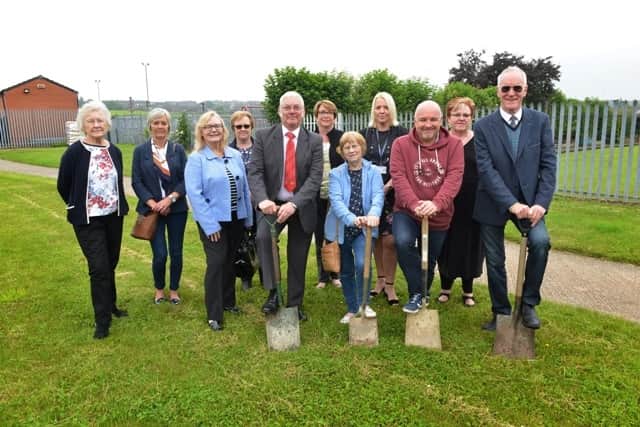 The first sods are cut, led by Cllr Alan Buckley (centre) as building work begins