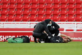 Shaun MacDonald is injured at Stoke City last Saturday