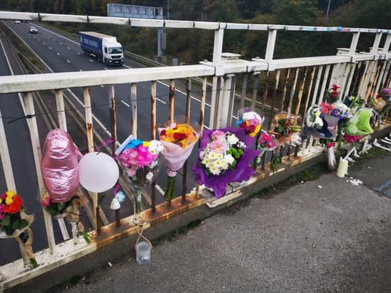 Tributes left on the bridge over the M18