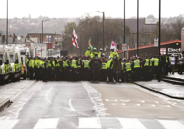 Members of the English Defence League make their way up Main Street
