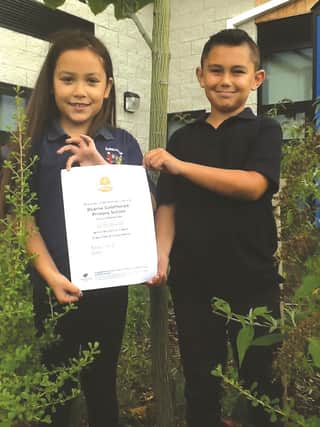 Kelly Clayton and Lucas Cooper with their Green Tree Schools Awards certificate