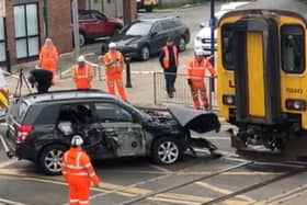 Network Rail staff work to remove an SUV from the track after it was hit by a train on a crossing at Redcar Central, Middlesbrough, on Wednesday May 1 2024. 