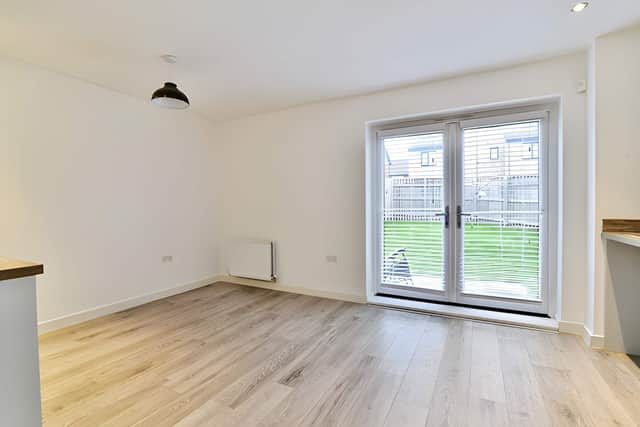 The bright lounge provides a welcoming reception space before the home opens into its contemporary kitchen and dining area