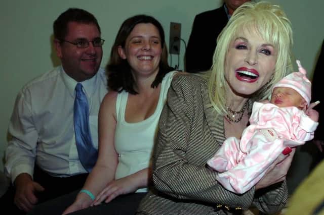 Dolly Parton meets baby Emma Jarman at Rotherham Hospital as her parents Shane and Claire look on