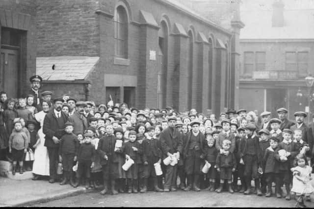 A crowd outside St Paul's Chapel, Parkgate, at a soup kitchen