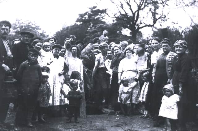 People from Church Street gather round a small coal pit in 1926