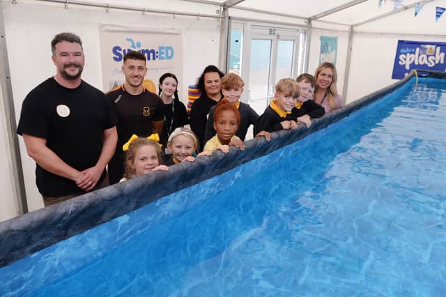 Some of the pupils are pictured with, from left to right: Activ8 director Owen Wedgwood, swim operations manager Adam Winder, lifeguard and swimming teacher Rhianna Johnson, lead swimming teacher Jo Hopson and head teacher Daisy Dunning.