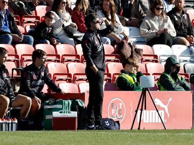 Rotherham United boss Alex Bruce watches proceedings at sunny Fleetwood Town.
