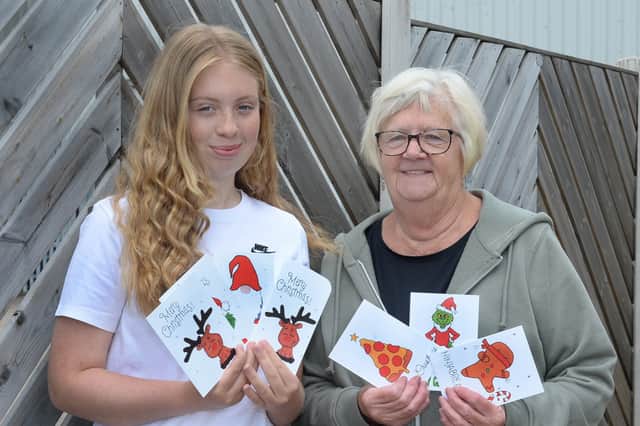 Charlotte Oram with her 2025 Christmas cards for the Rotherham Families First Christmas Toy Appeal, pictured with charity founder Ann Levick.