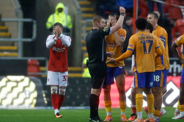 Referee James Oldham sends off Shrewsbury Town's Kian McMahon-Brown against Rotherham United