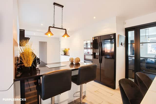 The contemporary kitchen and dining area opens into the orangery