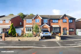 The detached Farm View Road property has off-road parking and a garage with an electric door