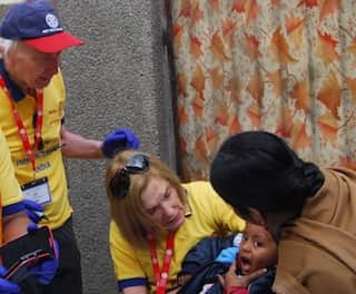 Jane, wife of current President, Geoff Cooper, vaccinating very young children in India as part of a National Day