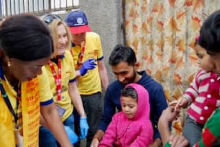 Jane and Geoff and a fellow volunteer during the vaccination day