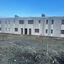 Outline planning permission was granted in September 2025 to demolish two blocks of housing, known locally as the derelicts.