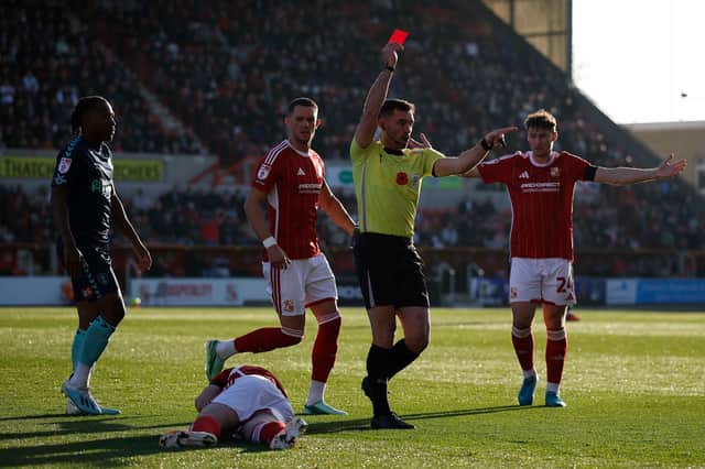 Rotherham United's Jili Buyabu is shown as red card at Swindon Town