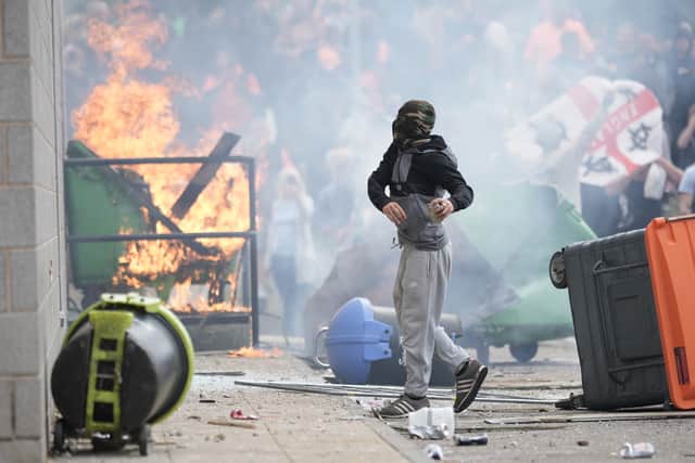 ROTHERHAM, ENGLAND - AUGUST 4: Anti-migration protesters are seen during riots outside of the Holiday Inn Express in Manvers, which is being used as an asylum hotel, on August 4, 2024. (Photo by Christopher Furlong/Getty Images)