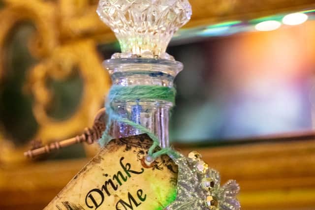 Alice's adventures begin when she tumbles down a rabbit hole and drinks a magic potion