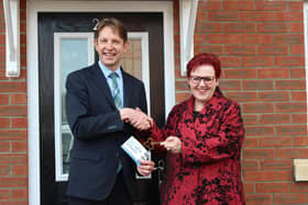 Paul Walters, Harron Homes North Midlands sales manager, hands over the key to the 500th property to Rotherham Council's deputy leader Cllr Sarah Allen
