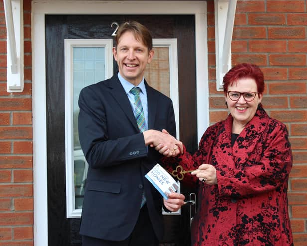 Paul Walters, Harron Homes North Midlands sales manager, hands over the key to the 500th property to Rotherham Council's deputy leader Cllr Sarah Allen