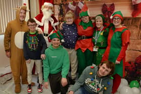 Staff and students at Forest view pictured in the grotto with Santa and his elves, during the recent Christmas Fair.