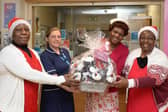 As part of their winter warmth project, ladies from the Friendly Domain Services social group knitted 60 hats for Christmas babies born at Rotherham Hospital. Labour ward lead Alex Birks (second left) is seen receiving the gift from (left) to right: Naume Chisambara, Consilia Ngadze and Shelter Ehitiyo..
