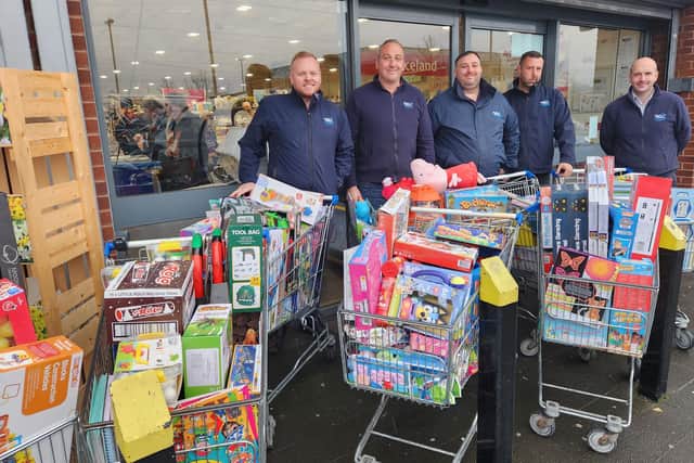 Newell staff with trollies of gifts