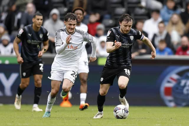Rotherham United's Ollie Rathbone races away in the rain at Swansea City. Picture: Jim Brailsford