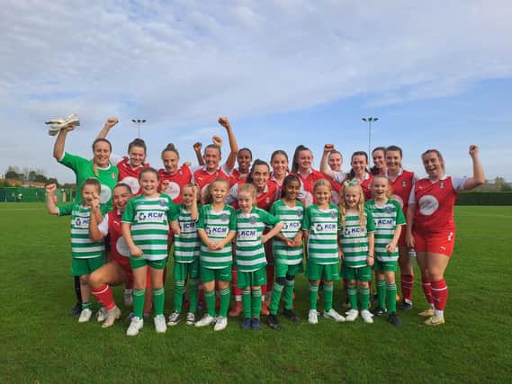 Victorious Rotherham United Women with mascots from Rawmarsh St Joseph's Under-9 Girls.